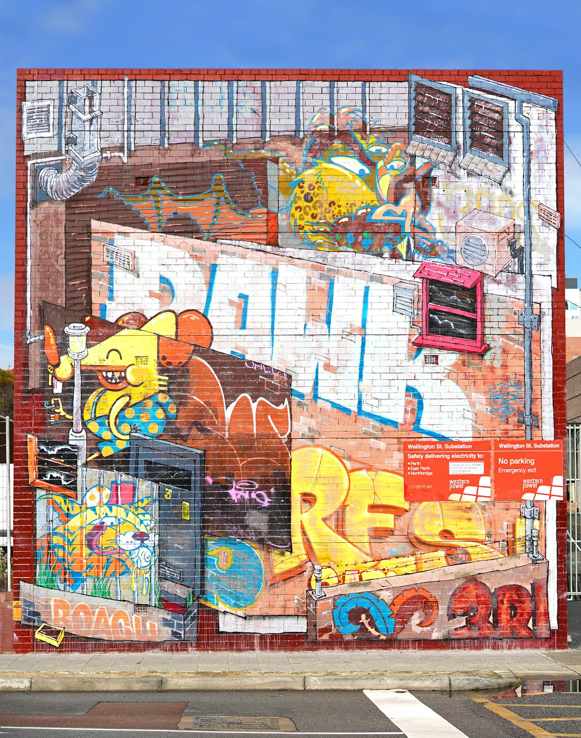 Street art mural covers entire brick wall with cartoon urban scene.